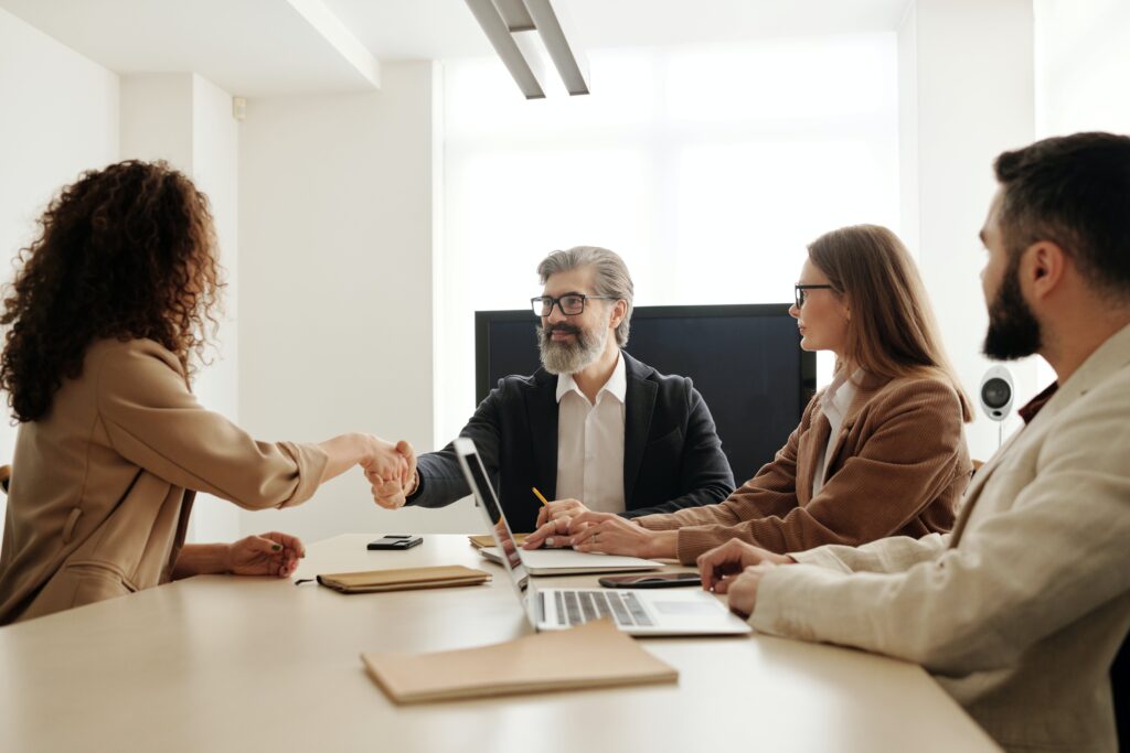 Professional team discussion in a dynamic workplace, symbolizing TopRecruitment's Direct Hire service